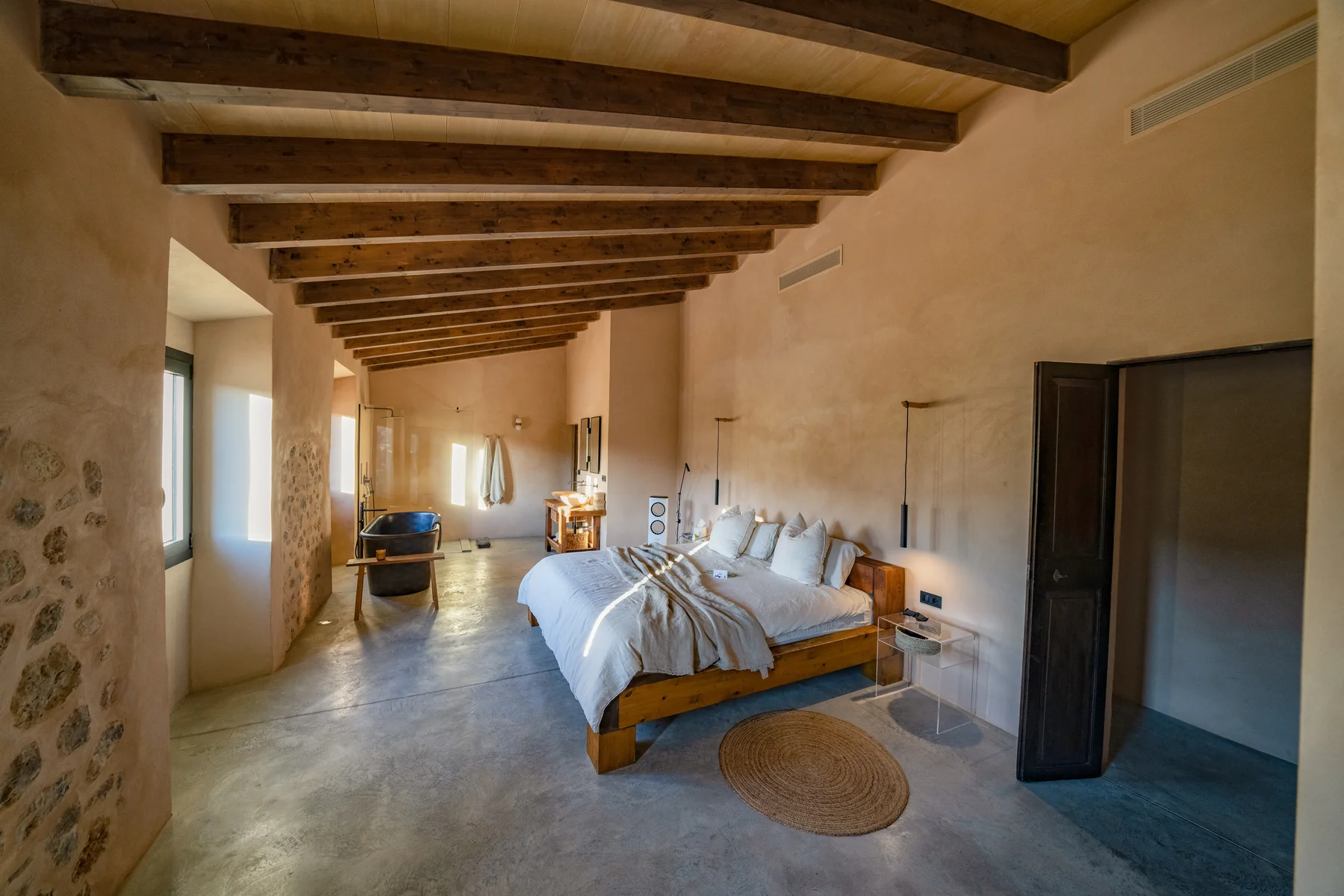 The master bedroom — generous proportions, beamed ceiling and natural light