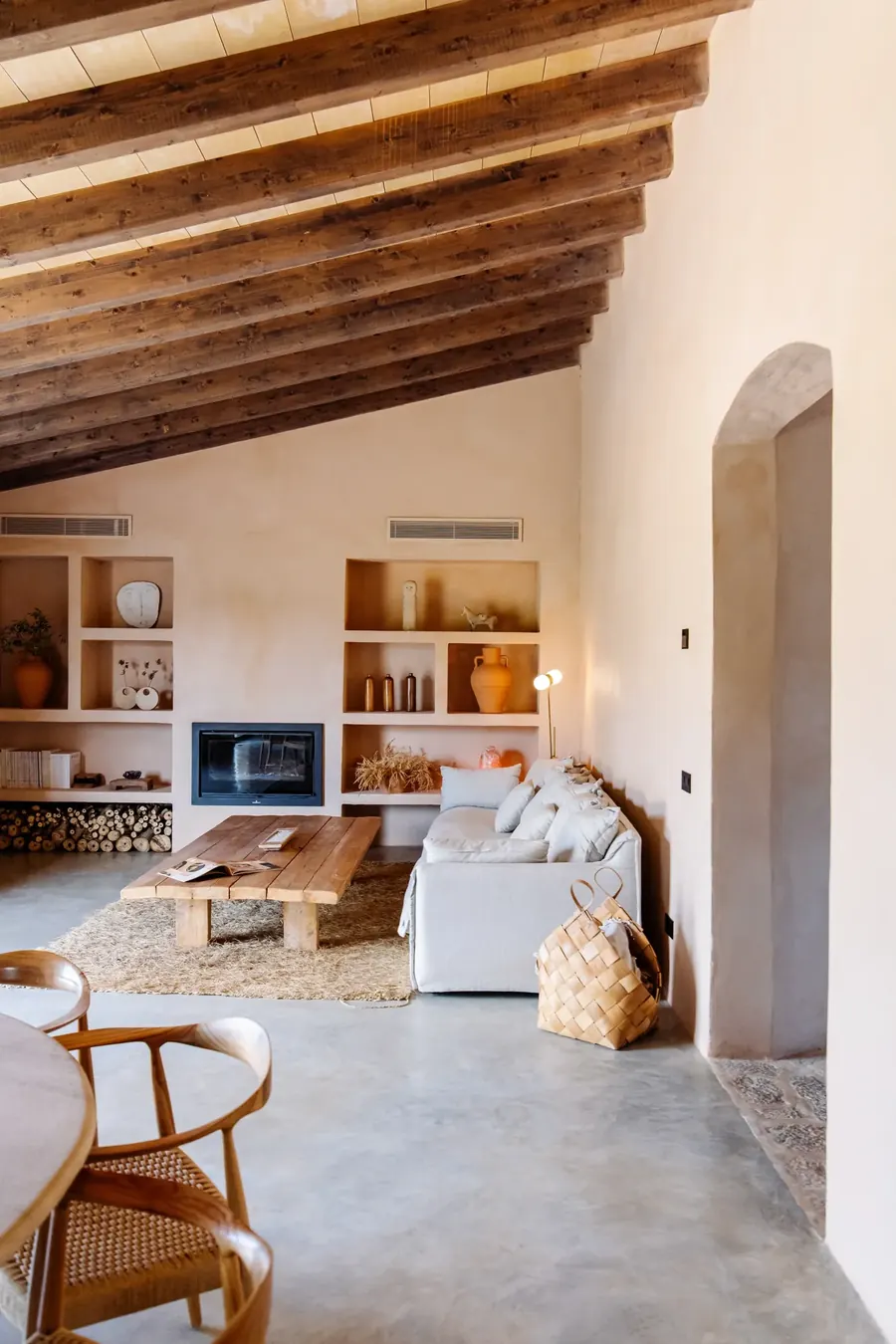 The living room — fireplace, shelves and warm afternoon light