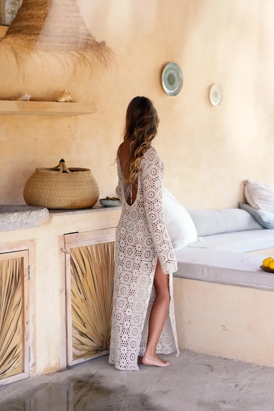 The outdoor kitchen — warm stone, ceramics and late-afternoon light